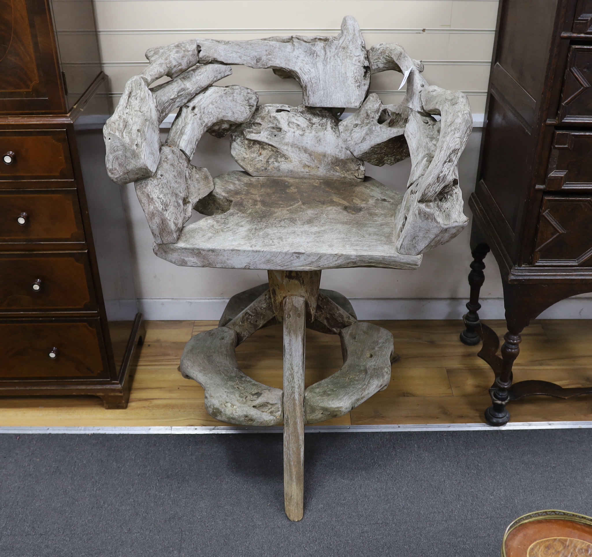 A pair of rustic bleached wood swivel garden chairs, width 96cm, depth 57cm, height 119cm